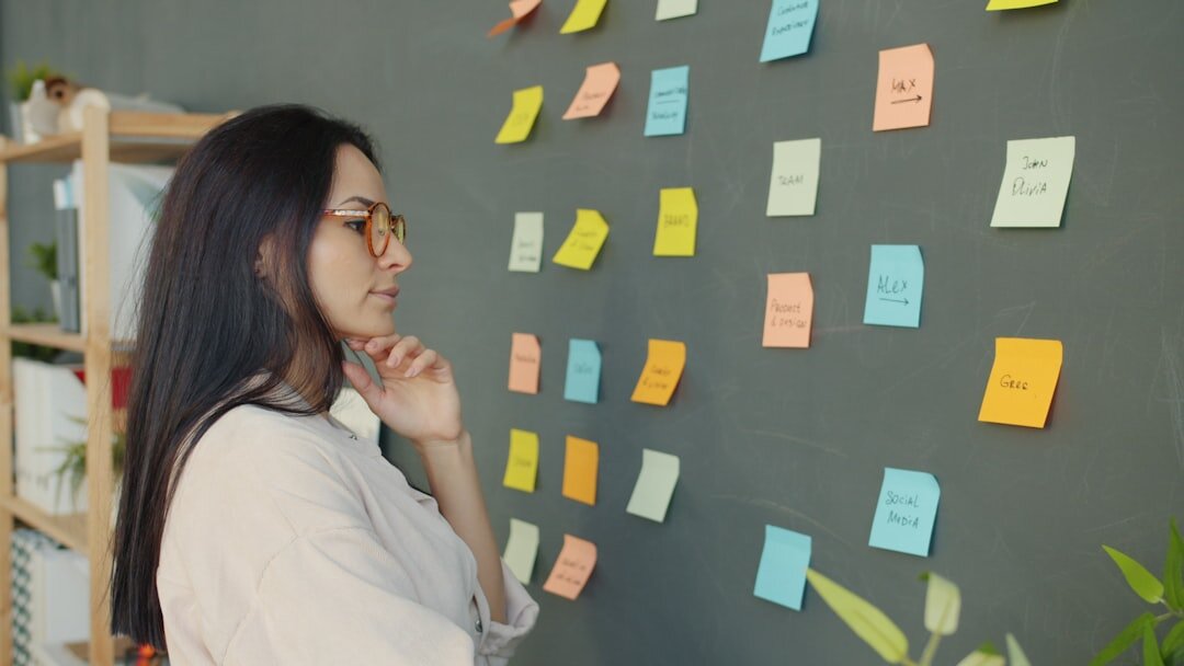 Startup team brainstorming with laptops and sticky notes in modern office