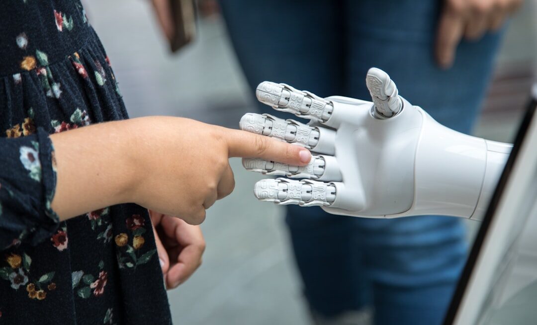 Robot hand touching human hand in AI collaboration concept
